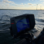 Garmin fish finder equipped with PikeTech PRO Visor during a fishing trip in bright sunlight
